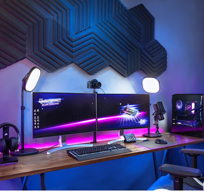 Elgato Key Light Air shown illuminating office setup on either side of a wide monitor with a video camera set between them