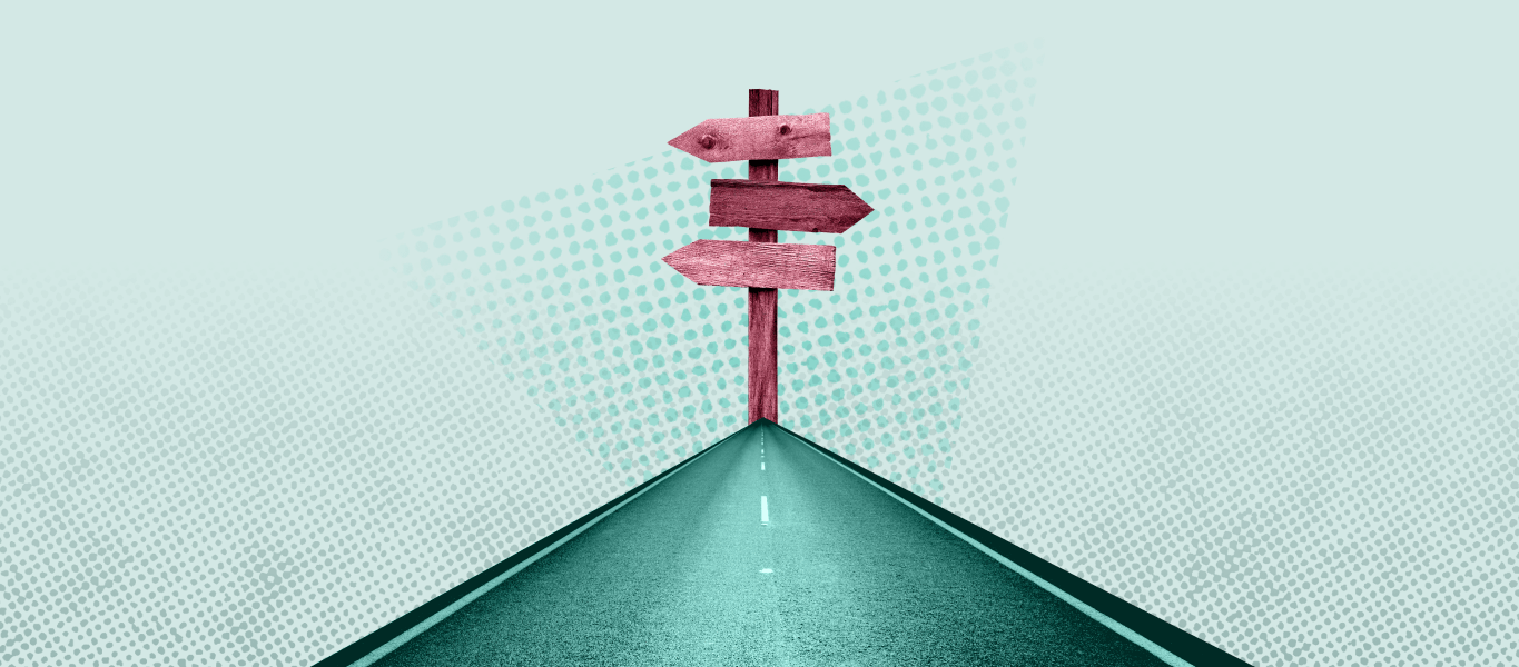 A green road leads to a pink sign with arrows pointing in different directions.