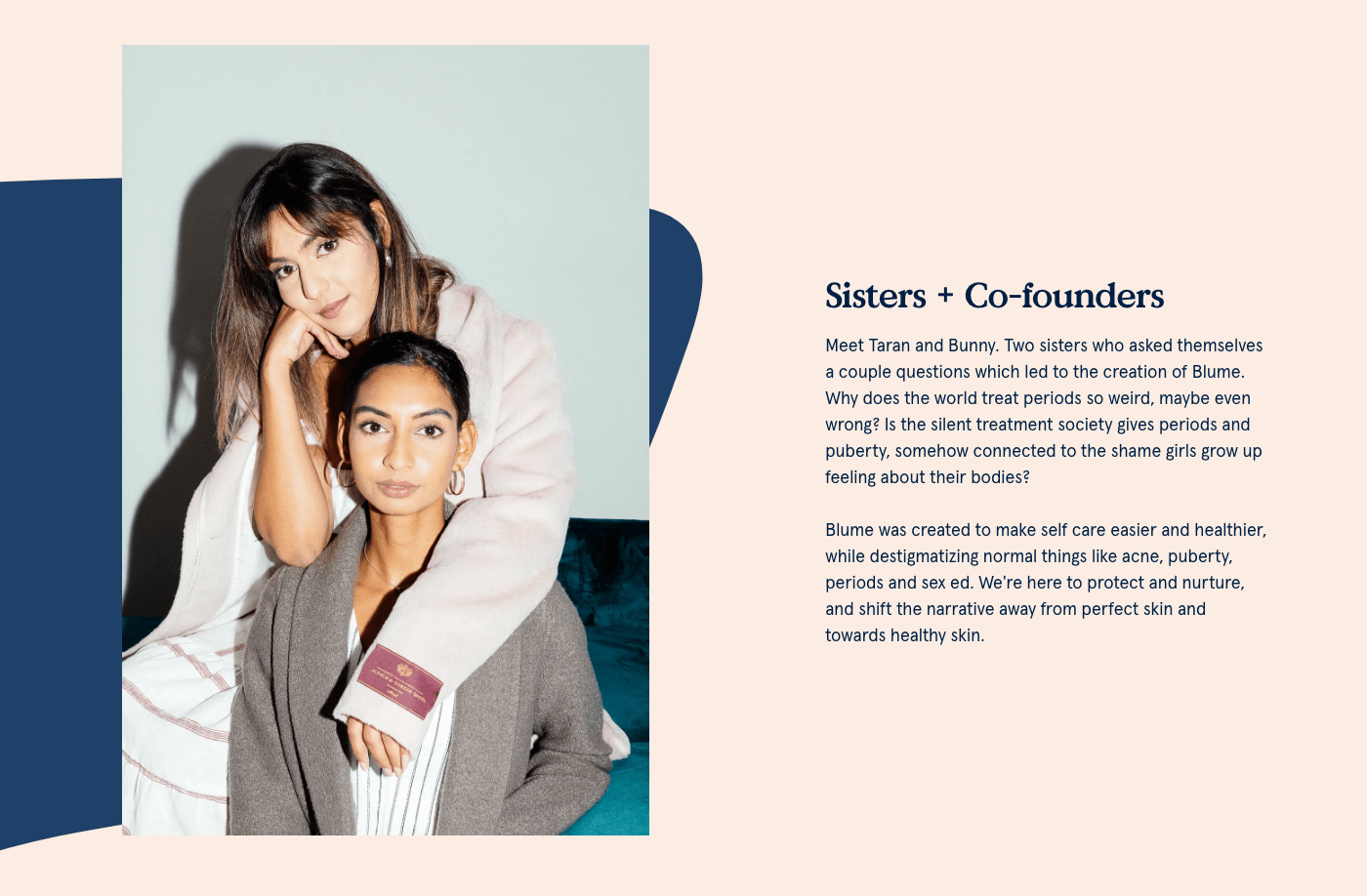 On the Blume About Us page, Taran and Bunny Ghatrora, sisters and co-founders of Blume, lean on each other while smiling at the camera