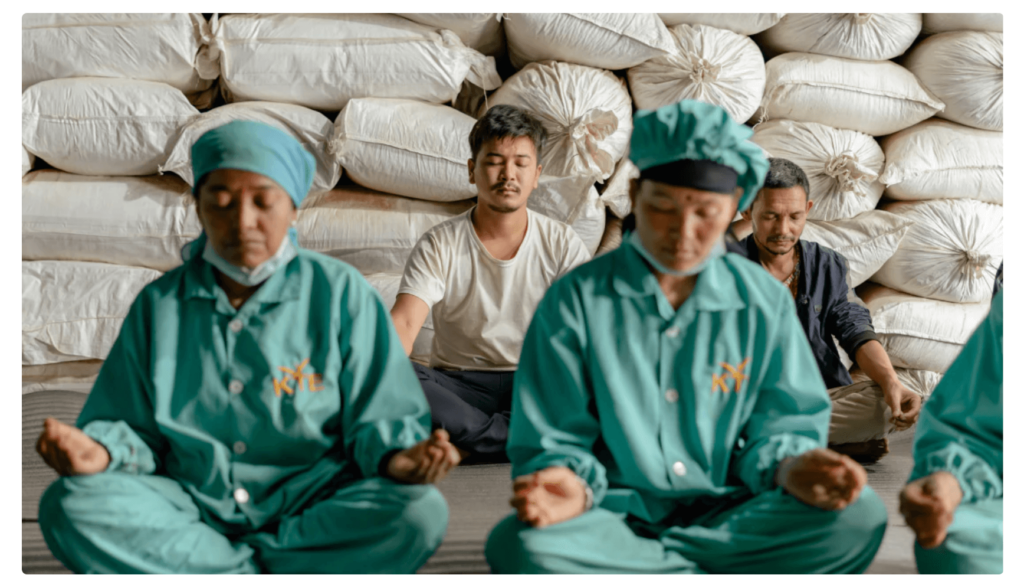 Tea farmers take a moment to meditate.